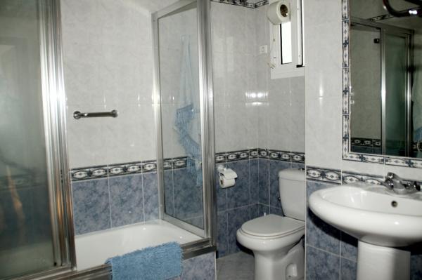 Cuarto de baño. Bañera con ducha, bidé, lavabo, inodoro, Gel, Champú, papel higiénico, secador de pelo, y toallas.